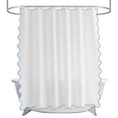 a white shower curtain with blue scallops on the edge and a bath tub underneath it