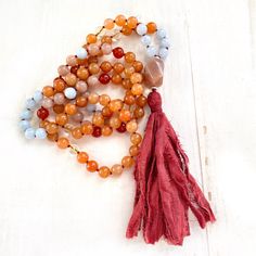 "A wonderful Mala for helping with insecurities. Handcrafted with Aquamarine for support when feeling overwhelmed and Peach Aventurine for assistance when making decisions. This Mala also consists of Sunstone which is known as a stone of leadership and personal power along with Carnelian to calm temper and give a sense of humor. An accent stone of Citrine is worked in for joy and happiness. All these healing stones are hand knotted into this beautiful 108 bead Mala. Charm not included, please se Aventurine Gemstone Beads Necklace For Healing, Spiritual Amber Beaded Necklaces With Natural Stones, Spiritual Amber Beaded Necklace With Natural Stones, Hand-strung Orange Beads As A Gift, Spiritual Hand-strung Amber Beaded Necklaces, Amber Crystal Necklace For Meditation With Natural Stones, Bohemian Orange Jewelry For Meditation, Bohemian Orange Crystal Necklace With Natural Stones, Orange Bohemian Crystal Necklace With Natural Stones