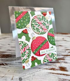 a christmas card with ornaments on it and the words all is merry written in white