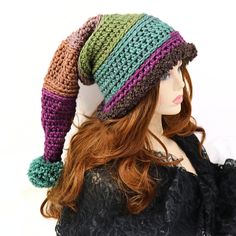 "Make winter fun with this thick and warm witchy stocking hat. I've crocheted this with a chunky yarn and a brown Sherpa brim that can be pulled down over your ears. 21\" long from the tip to the brim, this hat has enough body that it can be worn with the tip hanging down or tucked into a more upright shape, and the end has a matching pom pom. Certain to add fun character to your winter outdoor wear or gift to a friend who needs that extra warmth. Works for him or her! Lots of stretch, so one si Funky Winter Hat One Size Fits Most, Whimsical Winter Beanie Costume Hat, Whimsical Beanie Costume Hats For Winter, Whimsical Adjustable Crochet Winter Hat, Funky Winter Beanie Hats, Fun Green Crochet Hat For Winter, Green Fun Crochet Hat For Winter, Adjustable Fun Crochet Hat For Winter, Whimsical Purple Winter Hat