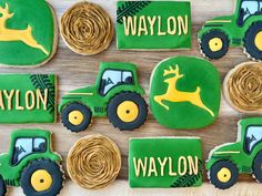 tractor cookies decorated with green icing and yellow frosting are arranged on a table