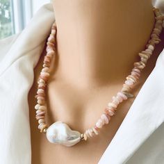 "Add a touch of elegance to your jewelry collection with this stunning Pink Opal Chips and large Fresh Water Baroque Pearl Necklace. Handcrafted with love, this exquisite piece features vibrant pink opal chips beautifully complemented by a large fresh water baroque pearl centerpiece. The necklace is further enhanced by shimmering gold filled beads and a secure closure. Perfect for any occasion, this unique necklace will make a thoughtful and unforgettable gift for her. With a length of 18.5 inches, it effortlessly adds a pop of color and sophistication to any outfit. Embrace the beauty and grace of pink opal jewelry with this timeless piece. MATERIALS: Pink Opal Freshwater Large Baroque Pearl  Gold filled Measures 47cm or 18.5\"inches All Loulia Pearl Jewelry orders are carefully packaged Pearl White Gemstone Beads Necklace As Gift, Pearl White Gemstone Bead Necklace For Gifts, Pearl White Necklace With Gemstone Beads As Gift, Baroque Pearl Jewelry With Colorful Beads As Gift, Pearl White Gemstone Beads Necklace For Gift, Pearl White Necklace With Round Gemstone Beads, Elegant Pearl White Necklace With Colorful Beads, Baroque Pearl Jewelry With Colorful Beads For Gift, Gift Baroque Pearl Necklace With Polished Beads