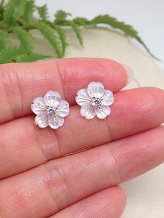 925 Sterling Silver Cz Mother of Pearl Flower Stud Earrings - Metal: 925 Sterling Silver (Finish: Rhodium Plated) - Stone: Lab-Created White Mother of Pearl, Clear Cubic Zirconia - Shape: Flower - Dimension: 11mm(0.43 in), Thickness 1.5mm/3mm (Thickness 3mm including center Cz stone). Cz Stone 2.8mm x 1.5mm. (Please note that the flower is 11mm, SMALL.) - Closure: Push Back (Post at center) - Color: Silver Sterling Silver Flower Earrings For Anniversary And Mother's Day, Fine Jewelry Flower Earrings In Cubic Zirconia, Fine Jewelry Flower Earrings With Cubic Zirconia, Fine Jewelry Flower-shaped Cubic Zirconia Earrings, Silver Cubic Zirconia Flower Earrings, Sterling Silver Flower Earrings For Anniversary, Diamond White Flower Earrings For Anniversary, Silver Cubic Zirconia Flower Earrings As Gift, Silver Cubic Zirconia Flower Earrings For Gift