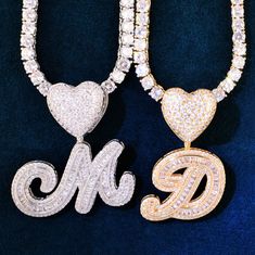 How about a little bling to accent your décolletage? This A Z Heart Bail Initial Cursive Letter Pendant With Tennis Chain is the perfect accessory to add a little sparkle to your outfit. The single letter pendant is adorned with cubic zirconia stones and comes on a gold-plated tennis chain. It's dainty, yet eye-catching and can be worn with just about anything. Whether you're dressing up for a night out or just want to add a touch of glam to your everyday look, this necklace is sure to do the tr Valentine's Day Cubic Zirconia Necklace With Chain, Cubic Zirconia Chain Necklace For Valentine's Day, Valentine's Day Heart Pendant Jewelry With Bling, Heart Pendant Necklace With Bling For Party, Bling Cubic Zirconia Necklaces For Valentine's Day, Valentine's Day Bling Cubic Zirconia Necklaces, Heart Cut Bling Necklace For Valentine's Day, Gold Bling Necklaces For Valentine's Day, Gold Bling Necklace For Valentine's Day