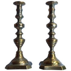 pair of brass candlesticks on white background