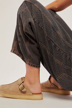 So cool and casual, these easy slip-on mules from Clarks feature a sleek suede upper with a dangling fringe detail and an attached logo fob. **Features:** Slip-on style, backless design, suede uppers, round toe, center seam, natural crepe rubber sole, pin buckle accents, tassel and fob accents **Why We | Clarks Trek Mules at Free People in Tan, Size: US 7 Comfy Shoes Clogs & Mules, Comfortable Leather Slip-on Mules, Natural Leather Slip-on Mules, Comfortable Slip-on Suede Mules, Casual Slip-on Mules With Buckle Closure, Train Trip, Suede Mules, Womens Mules, Clarks Women's