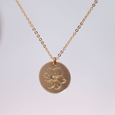 Celebrate their birthday with this dazzling Diamond Birth Flower Necklace. Each necklace features a stunning diamond and a unique birth flower charm, making it a perfect personalized gift. Show them how much you care (and know them) with this gorgeous and meaningful piece. Materials: 14k Gold Fill | 14k Rose Gold Fill | Sterling Silver Measurements: 16" chain, 18" chain Pendant: 5/8" coin Gold Flower Pendant Necklace For Anniversary, Birth Flower Jewelry For Anniversary, Gold Necklace With Flower Charm For Anniversary, Gold Necklaces With Flower Charm For Anniversary, Yellow Gold Birth Flower Jewelry For Anniversary, 14k Gold Flower Pendant Charm Necklace For Anniversary, 14k Gold Flower Charm Necklace With Pendant, Yellow Gold Jewelry With Birth Flower For Anniversary, Anniversary Jewelry With Flower Charm Pendant