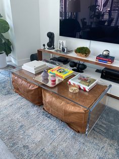 a living room with a couch, coffee table and television