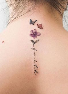 the back of a woman's neck with flowers and butterflies on her left side