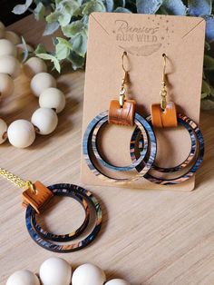 Unique Wood and Vegan Leather Earrings and Necklace Set for Her. Make a statement with these beautiful boho earrings and matching necklace. These wooden dangle earrings are a perfect gift for your best friend or a wonderful birthday gift for your girlfriend. Can be bought as just earrings, just a necklace or as a full set. The colorful wooden circles come in an array of fun colors with mainly blues, oranges, and some greens, soft pinks, and browns. All paired with a light brown faux leather and Bohemian Brown Earrings For Gift, Bohemian Brown Earrings As Gift, Everyday Artisan Multicolor Jewelry, Nickel-free Brown Hoop Earrings As Gift, Multicolor Bohemian Jewelry For Everyday Use, Multicolor Bohemian Jewelry For Everyday, Nickel-free Unique Jewelry For Everyday, Unique Nickel-free Jewelry For Everyday Use, Handmade Earrings For Everyday Use