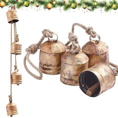 three bells are hanging from a christmas garland