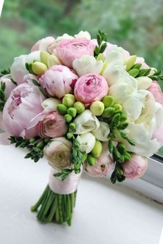 a bouquet of flowers sitting on top of a window sill