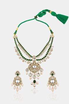 Unveil timeless elegance with this Layered Green Pendant Necklace Set, crafted with precision and style. The set is made from durable brass with a lustrous yellow gold finish, featuring a cascade of layers that exude sophistication. At its heart is a striking green emerald pendant, framed by sparkling Polki stones for an added touch of glamour. Delicate pearls are interspersed throughout, lending a classic, refined feel to the design. The vibrant green hues are balanced by the warm gold and the Hand Jewelry Rings, Green Pendant Necklace, Green Pendant, Green Pendants, Green Hues, Emerald Pendant, Emerald Necklace, Hand Jewelry, Vibrant Green