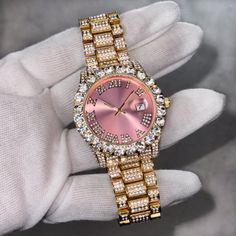 Step into elegance with this iced-out diamond timepiece that mirrors genuine luxury watches. We utilize premium simulated diamonds crafted from high-refractive crystals, ensuring a sparkle that rivals authentic diamonds under the light! INCLUDES AN EASY-TO-USE SIZE ADJUSTMENT TOOL Specifications: - Gender: Women's - Case Size: 42mm - Movement: Quartz Movement - Battery: Included - Sizing: 8.5-inch band - Adjustable: Links are removable to fit your wrist - Back: Stainless Steel - Lock: Deployment Clasp - Stone: VVS Diamond Simulate - Case Material: Alloy - Finish: Gold Plating  Whether you're dressing up for casual days, or events, or gifting someone special on occasions like Graduations, Valentine's Day, Anniversaries, Birthdays, Thanksgiving, Christmas, New Year, or Father's Day, this wat Luxury Quartz Movement Watch Bands As Gift, Luxury Gold Diamond Watch With Quartz Movement, Luxury Designer Watches With Quartz Movement, Luxury Square Watch Accessories With Quartz Movement, Luxury Stainless Steel Diamond Watch With Quartz Movement, Luxury Square-faced Watch With Quartz Movement, Luxury Diamond Watch With Quartz Movement For Anniversary, Luxury Diamond Jewelry And Watches With Quartz Movement, Luxury Timeless Diamond Watch With Bracelet Strap