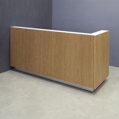 a wooden counter sitting next to a blue wall in an office building or conference room