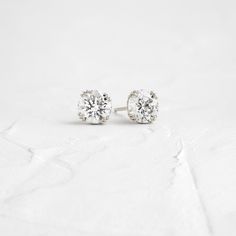 A pair of matching round brilliant cut diamonds in your choice of natural or lab-grown diamond. Please note: these earrings are listed with the total carat weight for both studs together. Each diamond is SI+ clarity, G+ color. Solid 14k gold posts and butterfly backings. Also available in platinum. Sold as a pair. We handcraft each piece with responsibly sourced metals and ethically sourced stones. Diamond White Solitaire Diamond Earrings, Round Lab Grown Diamond Earrings With Diamond Cut, Solitaire Diamond White Diamond Earrings, Diamond Cut Diamond Earrings, Fine Jewelry Diamond Cut Round Stone Earrings, Diamond Earrings With Prong Setting, Minimalist Solitaire Diamond Earrings, White Diamond Earrings With Single Diamond, Everyday Jewelry In Moissanite With Brilliant Cut