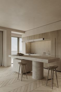 a kitchen with two stools next to an island in the middle of the room