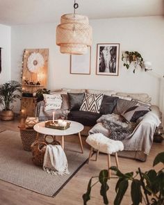 a living room filled with lots of furniture and decor on top of a hard wood floor