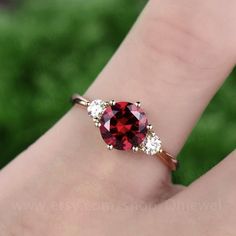 "This is a 1.25 carat garnet engagement ring in solid gold,about 7mm round cut. The accent stones are moissanites,forever classic quality. It can be made in any ring size. However please contact me to custom make it to a special big or small size. It can be made in white gold,rose gold or yellow gold with 14k or 18k. However for some people who are nickel allergic,I can also make it to 925 sterling silver to make you can wear it. The ring is handmade,very high quality! 30 days money back guarant Elegant Round Ruby Promise Ring, Classic Promise Jewelry With Lab-created Ruby, Classic Lab-created Ruby Jewelry For Promise, Elegant Red Moissanite Jewelry, Round Garnet Promise Jewelry, Garnet Solitaire Jewelry For Promise Ring, Round Garnet Jewelry For Promise, Fine Jewelry Garnet With Accent Stones, Fine Jewelry With Garnet And Accent Stones