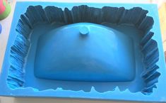 a blue square shaped cake pan sitting on top of a table