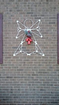 a red fire hydrant sitting on the side of a brick building next to a sign