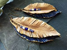 Handmade blue leather feathers earrings Handmade Blue Leather Earrings, Blue Bohemian Leather Earrings, Bohemian Blue Leather Earrings, Blue Leather Bohemian Earrings, Elegant Blue Feather Earrings, Elegant Blue Leather Jewelry, Adjustable Blue Feather Earrings, Blue Feather Earrings As Gift, Blue Feather Earrings For Gift