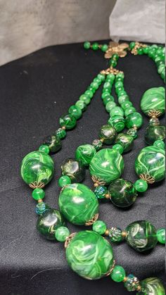 FREE SHIPPING- Vintage Multi Strand Necklace with Gold Tone Accents and Marbled Faux Jade Green Beads. See Item Description for Important info! Great Condition& Vibrant Greens~! There is a Maker's Mark signature under the Hook on the Butterfly, but it is hard to make out. FREE SHIPPING FOR ALL ORDERS GOING TO THE CONTINENTAL U.S.A (LOWER 48 STATES) ALL PURCHASES DESTINED FOR ALASKA OR HAWAII WILL INCUR SHIPPING CHARGES PLEASE SEE OUR PHOTOS ABOVE FOR DETAIL & CONTACT US WITH ANY QUESTION Vintage Beaded Necklaces With Colorful Beads, Vintage Large Beads For Jewelry Making, Vintage Polished Beads For Jewelry Making, Large Vintage Beads For Jewelry Making, Vintage Green Faceted Beads, Polished Vintage Beads, Vintage Green Beaded Necklace With Round Beads, Vintage Green Beads For Jewelry Making, Vintage Green Beaded Necklaces With Round Beads