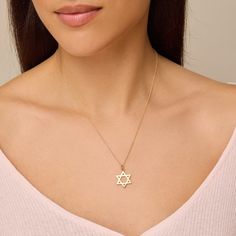 Our Large Star of David Pendant necklace features a hanging pendant handcrafted in 18-karat gold on a 18" link chain. A traditional symbol of Judaism and Jewish identity, this heirloom piece is a sweet gift for yourself or someone special and sure to be passed down through generations. Pendant hangs from 18", 14-karat link chain Pendant measures approximately 19.65mm x 16.75mm Spring ring clasp Made with love in Los Angeles Complimentary gift wrapping provided Elegant Star Of David Anniversary Jewelry, Elegant Gold Plated Charm Necklaces With Star Charm, Elegant Gold Plated Charm Necklace With Star, Elegant Star Of David Jewelry With Star Charm, Yellow Gold Star Of David Jewelry With Delicate Chain, Elegant Star Of David Hallmarked Necklace, Sterling Silver Star Of David Necklace With Polished Finish, Gift Delicate Chain Necklace With Star Of David Pendant, Yellow Gold Star Of David Necklace With Delicate Chain