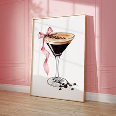 a painting of a martini glass with coffee beans on the rim and pink wall behind it