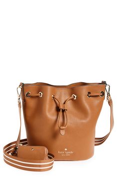 A sporty webbed crossbody strap brings a versatile finish to a pebble-grain leather bucket bag trimmed with glossy grommets. Drawstring top closure Optional, adjustable crossbody strap Lined Leather Imported Drawstring Top, Leather Bucket Bag, Leather Bucket, Crossbody Strap, Kate Spade New York, Cross Body Handbags, Bucket Bag, Gingerbread, Kate Spade