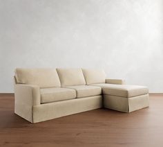 a white couch sitting on top of a hard wood floor next to a wooden floor