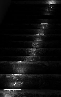 black and white photograph of stairs at night