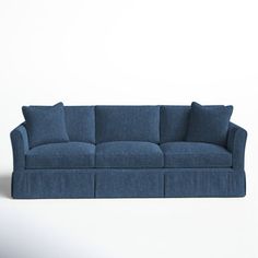 a blue couch sitting on top of a white floor