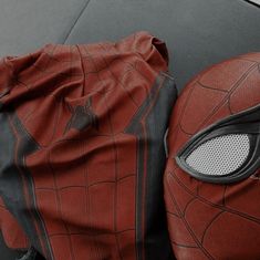 a pair of spider - man mask and bag sitting on top of a table