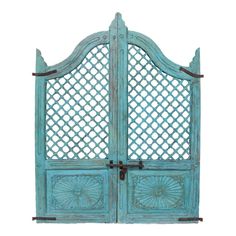 an old blue wooden gate with intricate carvings on the top and bottom panels, set against a white background