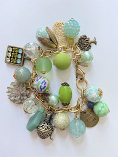 Beads and baubles in green hues Green Bracelet With Lobster Clasp, Bohemian Dangling Charms For Jewelry Making, Elegant Green Metal Charm Bracelet, Green Dangle Jewelry With Charms, Green Dangle Jewelry With Dangling Charms, Green Dangling Charms For Gift, Green Dangling Charms Jewelry, Green Bohemian Jewelry With Charms, Green Metal Beaded Bracelets For Jewelry Making