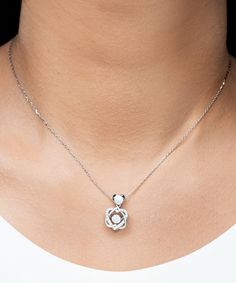 - Heart Knot Silver Necklace: Weight: 0.2 oz - The pendant is 0.75 inch (19mm) in length and 0.45 inch (11.5mm) in width. - Final product is hand polished in Miami Fl. and shipped fast to your door. - Our Alluring Luxury box will bring a touch of luxury to your jewelry. - Stunning .925 Sterling Silver necklace. - AAAA grade cubic zirconia jewels set throughout the necklace. - The chain length is 15.75 inches including a 1.97 inch extender. - The pendant can be removed from the chain. - Polished Heart Knot, Sterling Silver Heart Pendant, Golden Necklace, Silver Heart Pendant, Silver Heart Necklace, Mom Necklace, Exclusive Gift, Knot Necklace, Black Box