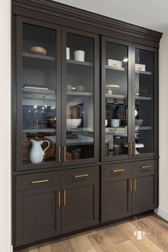 a large glass door cabinet in a room