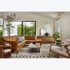 a living room filled with furniture and windows