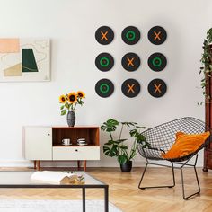 a living room filled with lots of furniture and decor on top of hard wood flooring