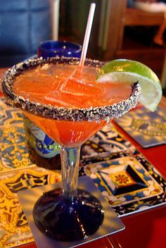 a margarita sitting on top of a red table