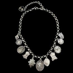 Our Miraculous Madonnas Charm Necklace is features 12 Vintage Reproduction charms with variety of Old World Madonnas and a Miraculous Medal focal point. Among the Madonnas are a vintage Saint Benedict cross, St. Therese the Little Flower, a Fleur de Lis and Saint Michael and the Dove of Peace also known as the Holy Spirit. These charms are made in New England by our silversmiths. Length: 18" and fully adjustable Materials: Sterling Silver clad bronze Heirloom Silver Necklace With Charms, Heirloom Silver Necklaces With Charms, Vintage Sterling Silver Charm Necklace, Vintage Silver Necklaces With Charms, Silver Charms Necklace For Vintage Collection, Vintage Collection Silver Necklaces With Charms, Silver Charms Necklace From Vintage Collection, Vintage Silver Necklace With Dangling Charms, Vintage Sterling Silver Necklaces With Dangling Charms