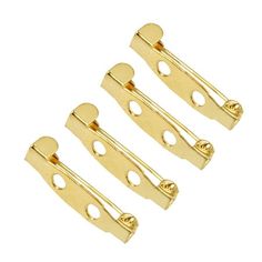 three gold plated metal clips with holes