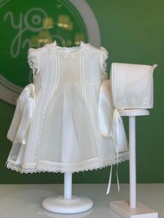 Made in Spain White A-line Dresses With Lace Collar, Sleeveless Lace Dress For Ceremonies, White Sleeveless Dress With Smocked Bodice, Off White Lace Dress For Baptism, White Sleeveless Lace Baptism Dress, White Lace Bodice Fitted Dress, Classic Lace Dress With Ruffles, Off-white Lace Dress For Baptism, White Dresses With Smocked Bodice