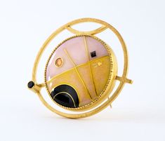 This modern convertible brooch pendant has a 24K gold cloisonne vitreous enamel on silver jewel in a geometric design with deep black, petal pink and warm yellow set into gold vermeil over sterling silver with faceted black spinel, enamel measures 1" diameter, overall 1.5" *please use my contact page to request additional details Luxury Gold Enamel Pin Gift, Luxury Gold Enamel Pin As Gift, Luxury Gold Enamel Pin For Gift, Contemporary Formal Brooch Jewelry, Modernist Gold Brooch Jewelry, Modernist Gold Brooch, Modern Gold Enamel Jewelry, Unique Yellow Gold Enamel Brooch, Contemporary Gold Gemstone Jewelry