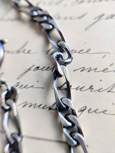 Nice silver watch chain with a c clasp and a dog clasp, with patina. The watch chain is in good antique condition, but has traces of wear due to its age. Length: about 29 cm. Metal Figaro Chain Link Bracelet, Silver Chain Necklace With Hook And Links For Gift, Silver Link Chain Bracelet With Lobster Clasp, Engraved Metal Chain Link Bracelet, Classic Silver Necklace With Hook And Links, Silver Chain Link Bracelet With Lobster Clasp, Silver Chain Bracelet With Lobster Clasp, Vintage Silver Figaro Chain Necklace, Silver Figaro Chain Link Bracelet