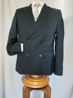 "Made by H & M  Romania of beautiful Italian wool,  this well cut double breasted jacket is  light weight, comfortable and elegant.  Two front tabbed pockets, two breast pockets plus ticket pocket. Excellent condition. Shoulder to shoulder 17\",  chest 38\",  sleeve 25\",  shoulder to hem 27\" and 40\" around the bottom." Winter Tuxedo Blazer With Double-breasted Button, Wool Tuxedo Outerwear With Double Button Closure, Formal Long Sleeve Sport Coat With Double-breasted Fastening, Double Breasted Tuxedo Suit With Long Sleeves, Classic Double Breasted Suit With Pockets, Black Double Breasted Suit With Long Sleeves, Winter Tuxedo Double Breasted Suit With Double Button Closure, Black Double Breasted Suit For Winter, Winter Black Double-breasted Suit With Double Button Closure