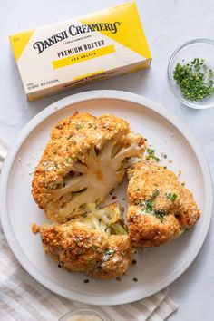 a white plate topped with cauliflower next to a box of danish creamers