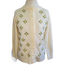 Vintage 60s Ivory Floral Embroidered Popcorn Cardigan Sweater Sz Medium. Off-white/ivory Long sleeve No interior tags Popcorn texture  Yellow flower embroidery Fits modern size medium Material feels like acrylic Medium knit thickness  Light wear to elbow of 1 sleeve Small snag on back as shown Buttons are popcorn Approximate measurements: Chest 36.5" Length 24" Retro White Cotton Cardigan, White Cotton Retro Cardigan, Vintage Cream Sweater With Floral Embroidery, White Vintage Cardigan With Floral Embroidery, White Retro Winter Cardigan, White Embroidered Crew Neck Outerwear, Cream Spring Sweater For Daywear, Cream Crew Neck Cardigan For Spring, Vintage Cream Embroidered Cardigan