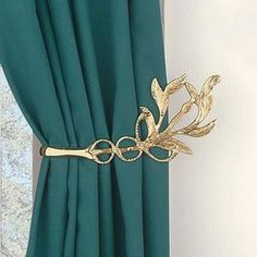 the curtain is closed and has a gold flower on it's rodulage